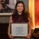 Gabriela Funez-dePaginer holding the Dr. Emilio Carrillo Award for Excellence in Research. 