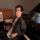 Ben Folds sits at a piano. 