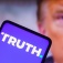Truth Social screen on a phone with a portrait of Donald Trum in the background. 