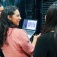 Viviana Monje (center) stands with two students as they look at a computer screen. 