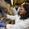 Three students in Miao Yu's lab work equipment to test the metal membranes they're working on. 