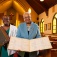 Zoom image: Lillian Williams (left) and Barbara Seals Nevergold display some of the St. Philip's church records that will be preserved by University Archives. Photo: Douglas Levere 