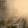 A metropolitan freeway with smog in the air. 