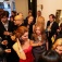 Adults at a cocktail party talking and mingling. 