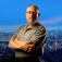 Mark Gottdiener pictured with a large city in the background. 