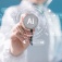 Concept of AI in healthcare featuring a doctor holding out a stethoscope with "AI" on it and healthcare-related icons surrounding it. 