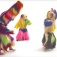 Video still from "Nick Cave's Soundsuits" featuring dancers in colorful, shaggy full-body costumes. 