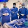 A group of sugeons in an operating room. 