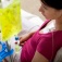 A young person receiving an infusion treatment for cancer. 