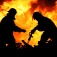 Fire fighters silhouetted against a raging fire. 