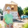Social Impact fellow Emily Dickey poses near a habitat for humanity house under construction. 