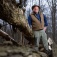 Nick Henshue pictured outdoors in a wooded area. 