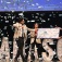 Panasci winners accept a large check as "money" confetti falls around them. 