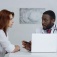 A patient listens as a doctor explains something. 
