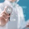 Person in physician's coat pushing a button labeled AI. 
