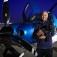 Brian Rambarran pictured holding a puppy in front of his plane. 