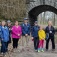 A group of people standing outdoors near a tunnel. 