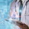 Concept of AI in healthcare featuring various healthcare icons and a doctor using an electronic computer pad. 