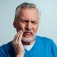 An older man experiencing oral pain. 