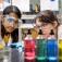 A young student and a professor observe an experiment. 