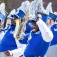 A member of a marching band celebrates a play during a homecoming football game. 