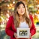 Tiffany Nhan, holding a family photograph. 
