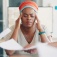 A person hold their temples looking stressed and over-burdened. 