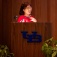 Soo-Kyung Lee speaking from a podium during Spotlight Symposi Series. 