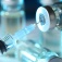 Close up of a syringe and vial of vaccine. 